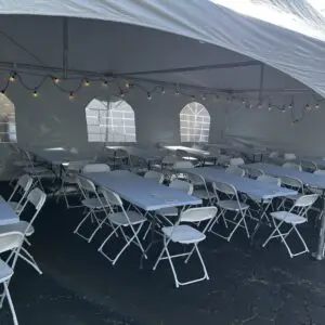 a white tent with tables and chairs in it