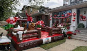 Guest riding mechanical bull during Valentine’s day parties with festive decorations and interactive entertainment attraction experience.